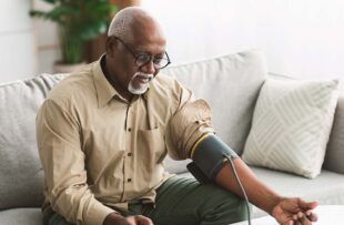 Man checking blood pressure at home.