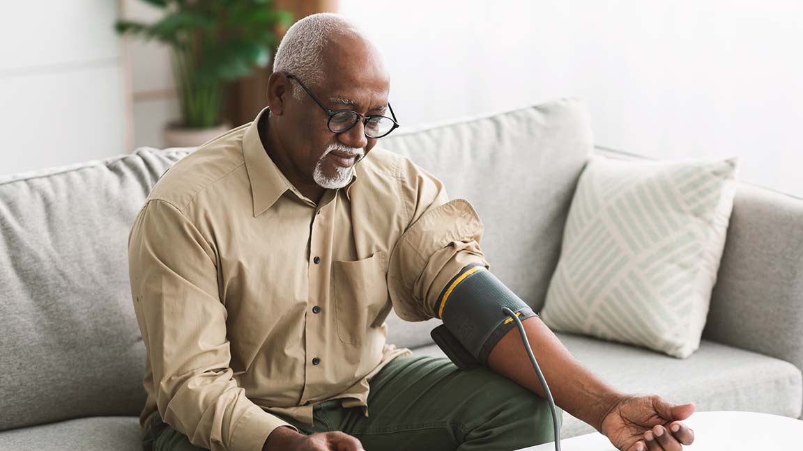 Man checking blood pressure at home.