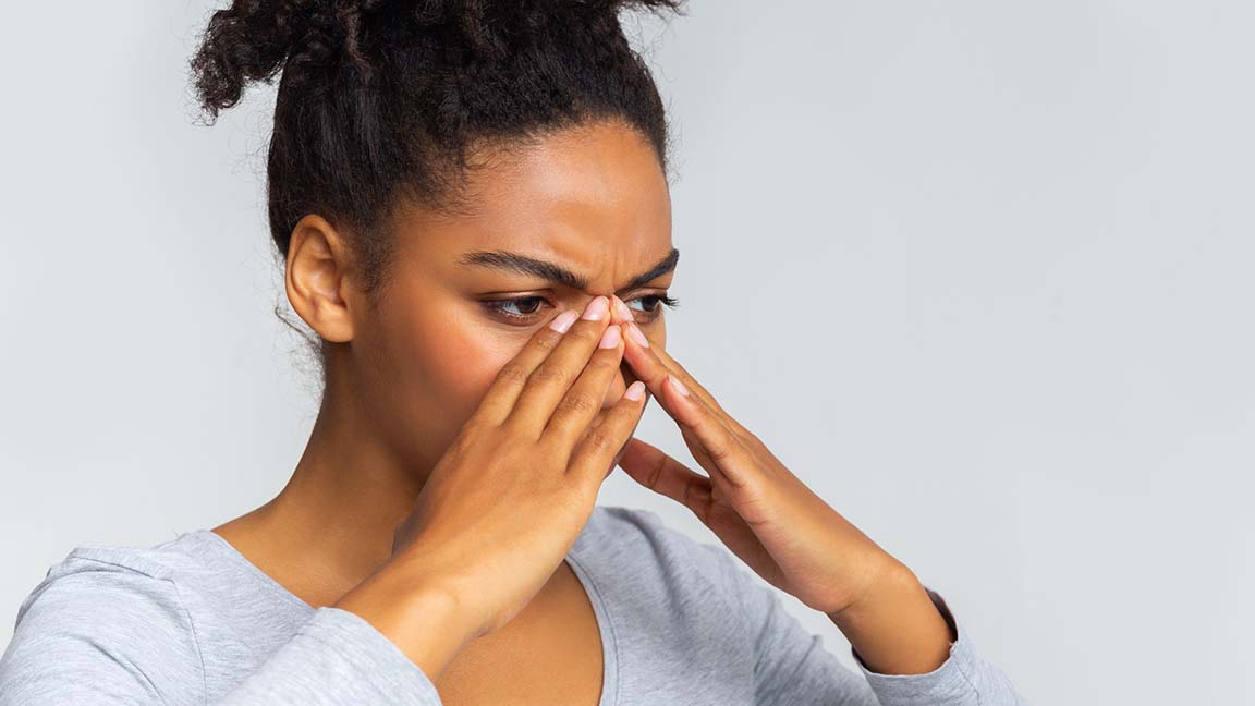Woman struggling with sinus infection.