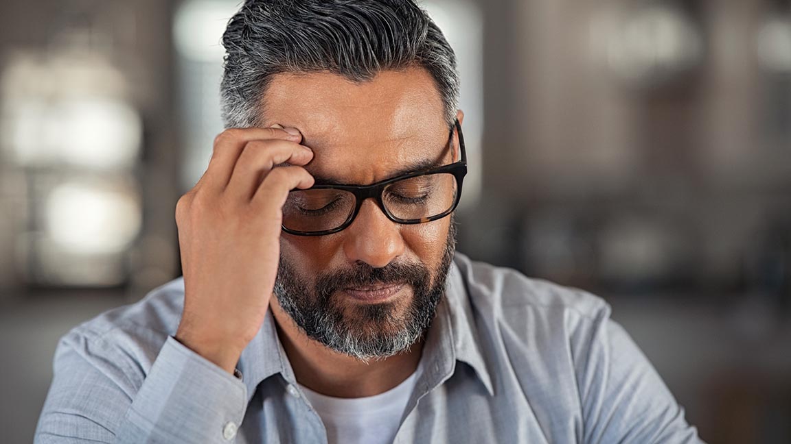 Man experiencing painful headache.