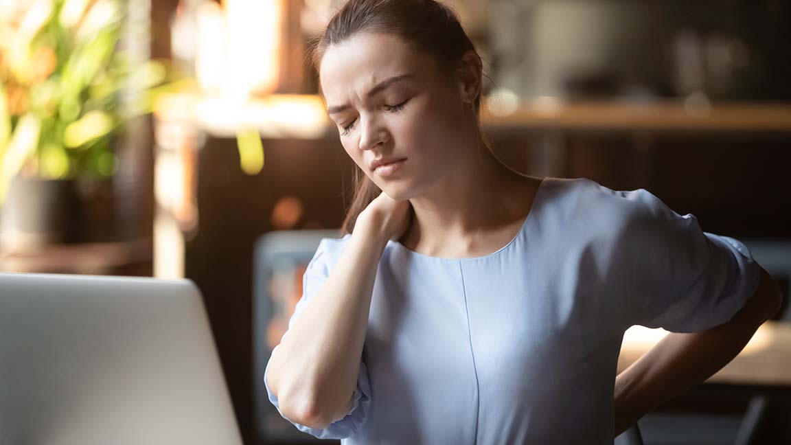 Woman suffering from neck pain.