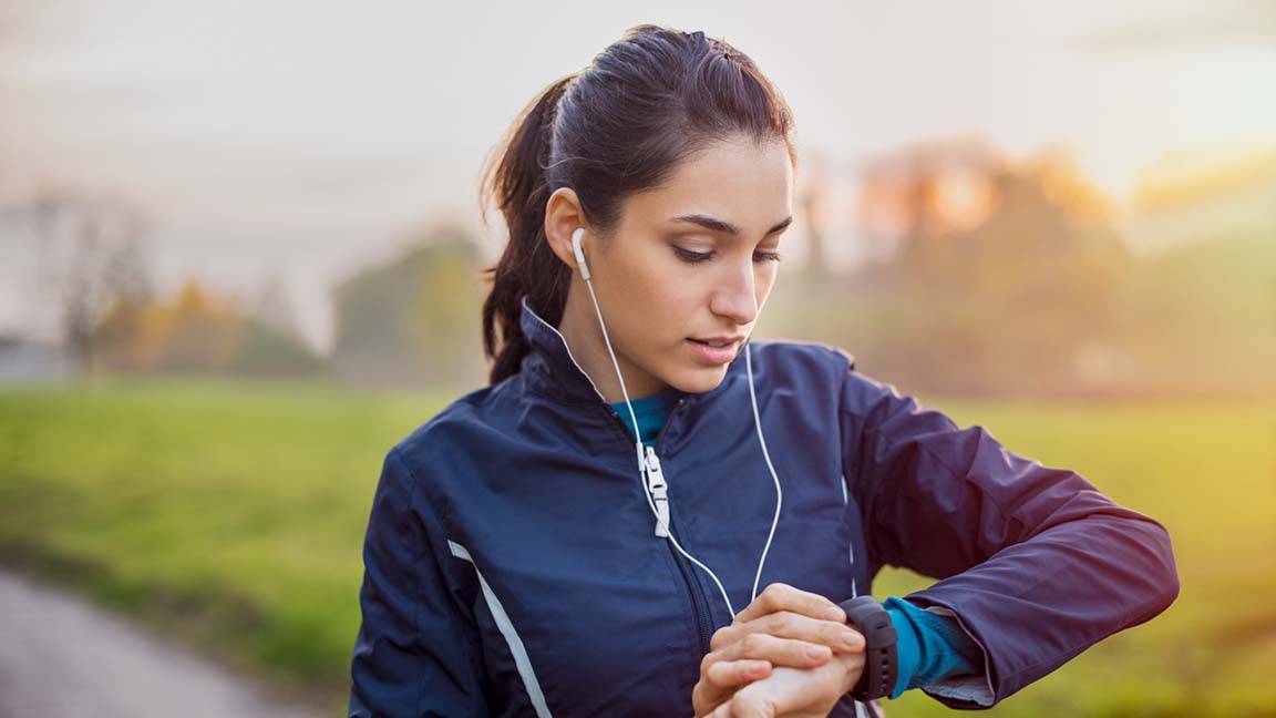 Woman using fitness tracker while working out.