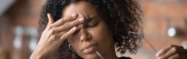 Woman struggling with migraine.