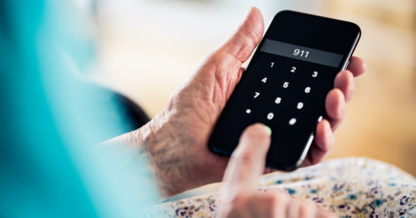 A woman holds a phone in her hands and dial 911