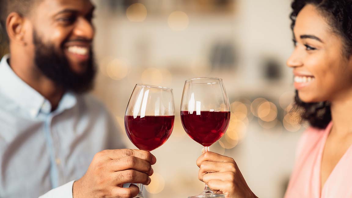 Couple drinking wine and smiling.