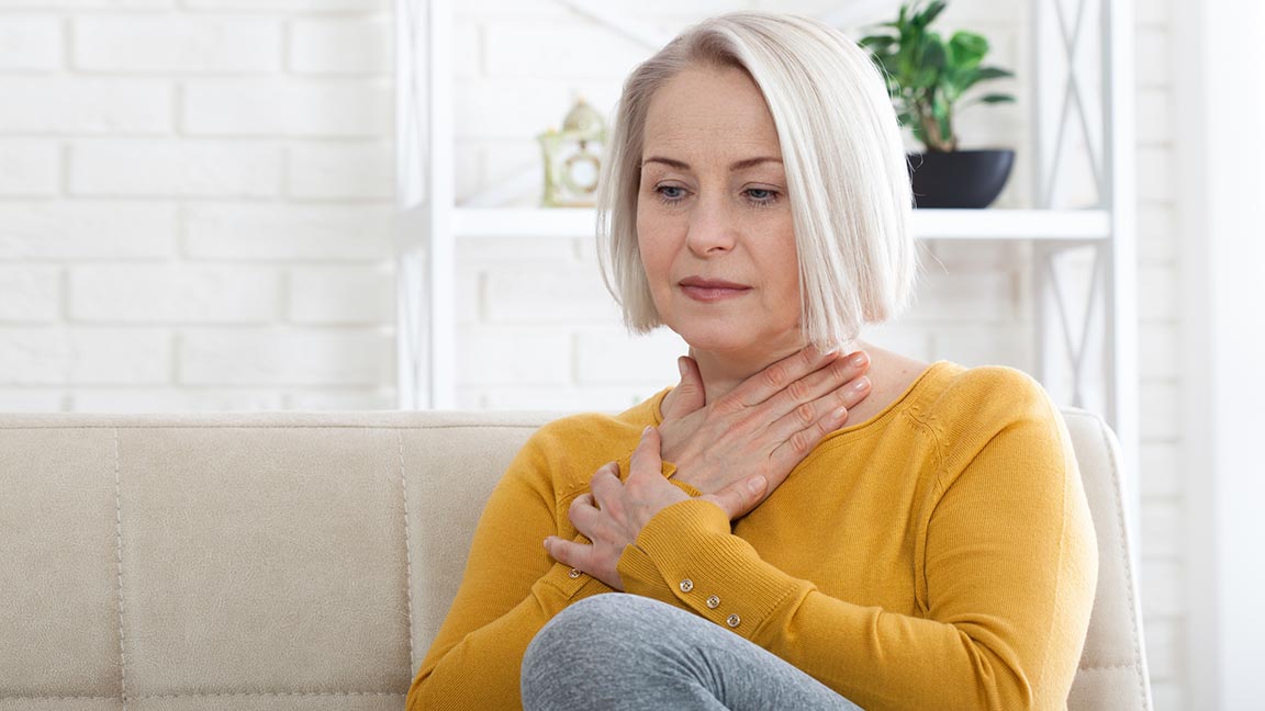 Woman struggling with GERD.