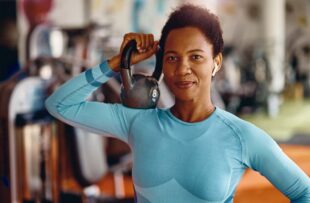 Woman holding kettlebell.