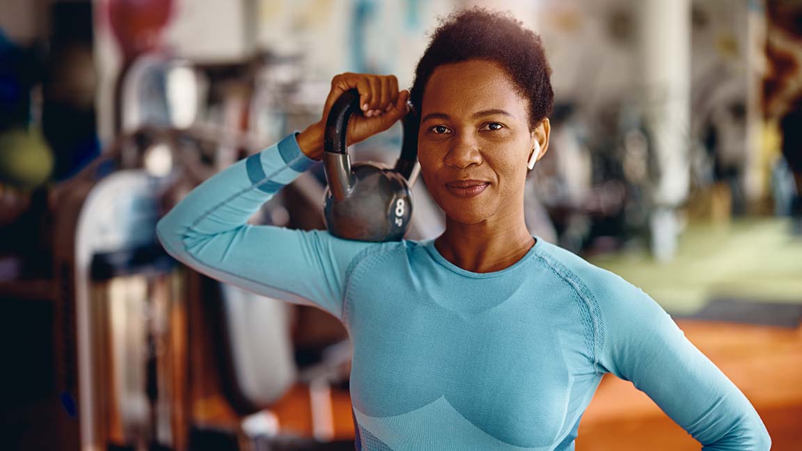 Woman holding kettlebell.