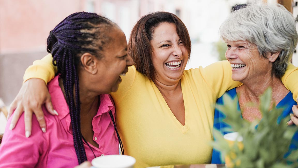 Friends chat while drinking coffee.