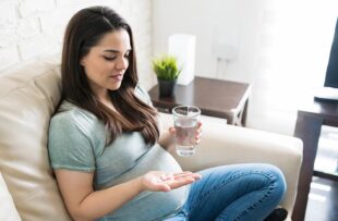Woman taking prenatal vitamins.