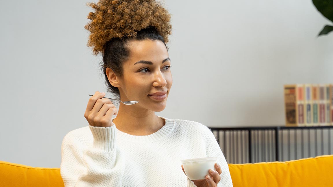 Woman eating yogurt.
