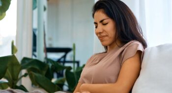 Woman struggling with abdominal pain.