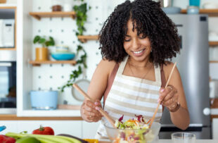 A woman consuming a healthy salad.