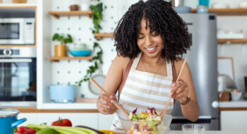 A woman consuming a healthy salad.