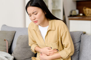 Woman struggling with stomach bug.