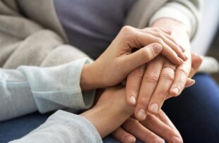 Close up of holding hands in a sign of support