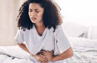 Woman struggling with abdominal pain.