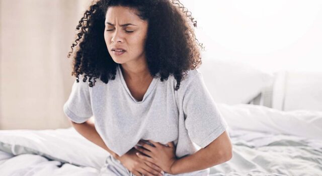 Woman struggling with abdominal pain.