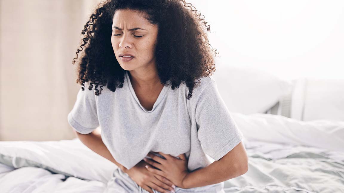 Woman struggling with abdominal pain.