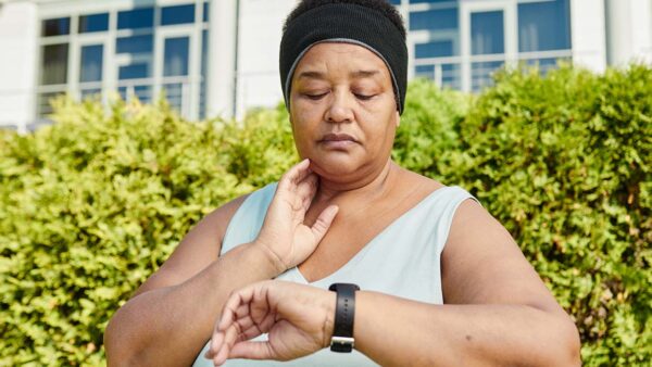Woman taking pulse.