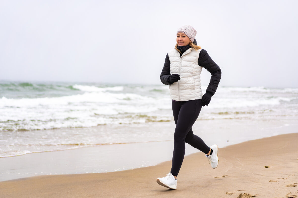 Mid-adult woman exercising on beach