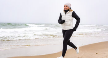 Mid-adult woman exercising on beach