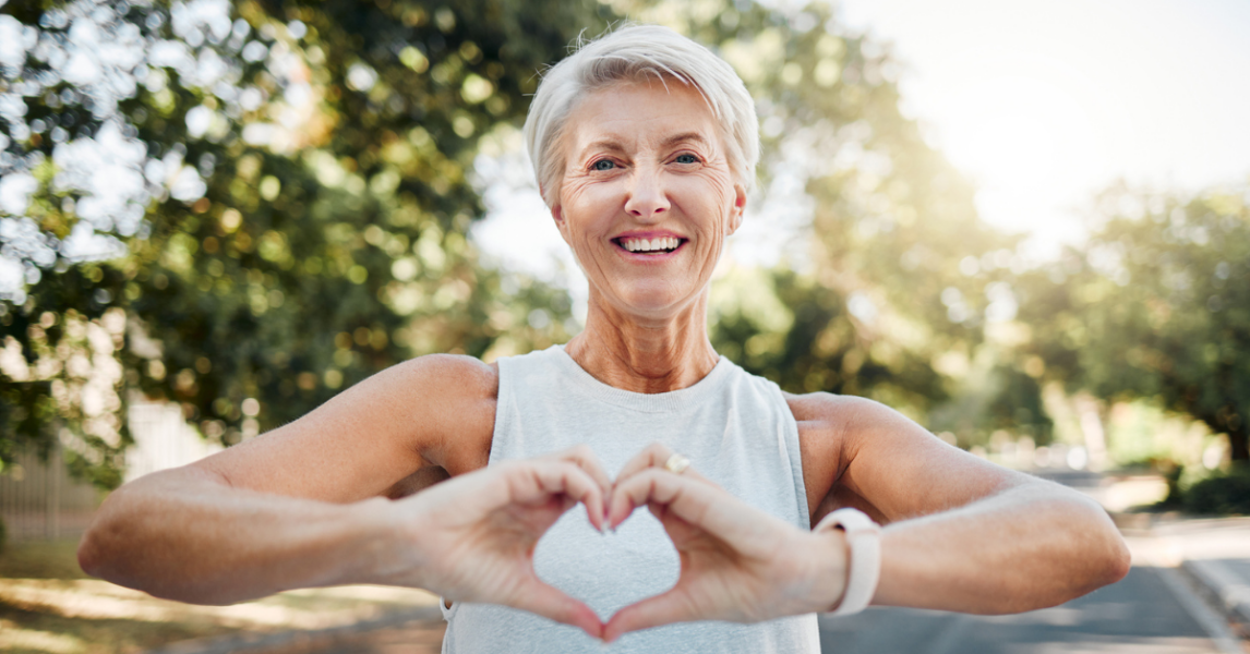 woman making heart shape with hands