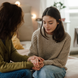 Teenage girl sharing problems with her mother in the room.