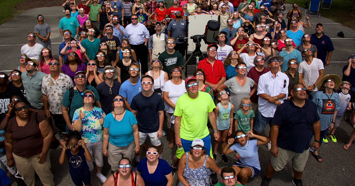 A group of people watching a solar eclipse.