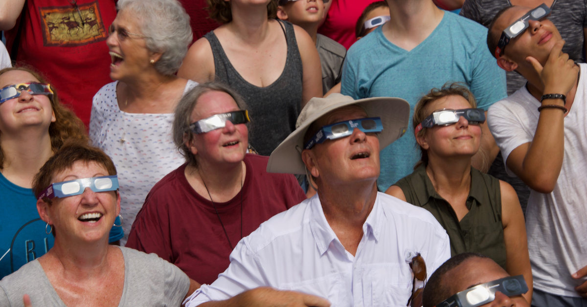 A group of people watching a solar eclipse.
