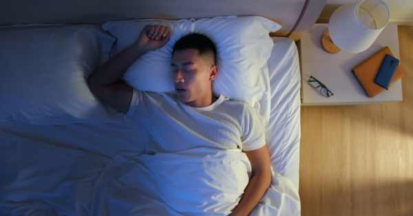young man snores when he sleep at night