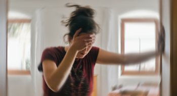 Woman suffering from vertigo or dizziness or other health problem of brain or inner ear.
