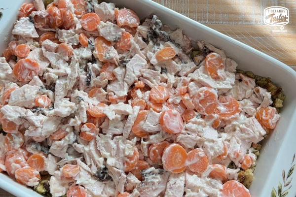 Vegetable mixture spread on top of the dressing mixture in a casserole dish.