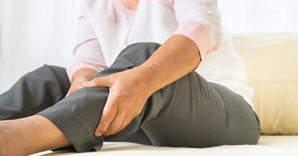 Leg pain of senior woman at home
