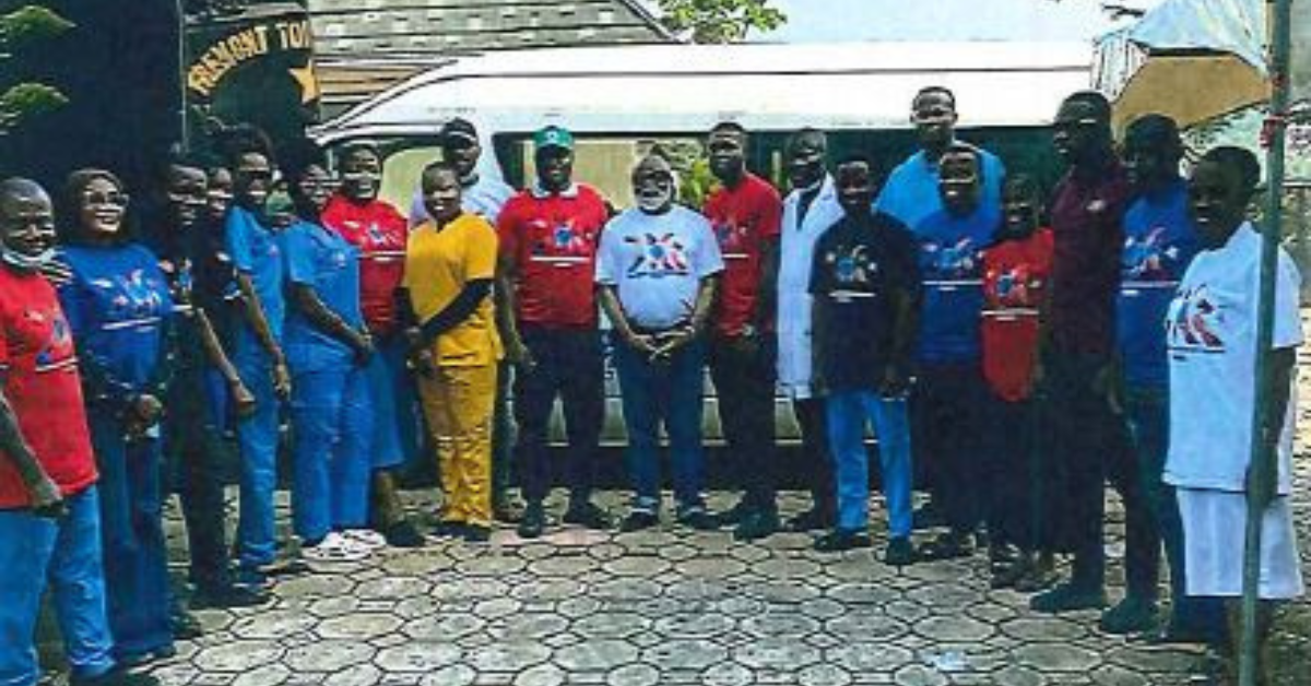 Dr. Ijem stands with a group of patients he cared for during his visit to Nigeria.