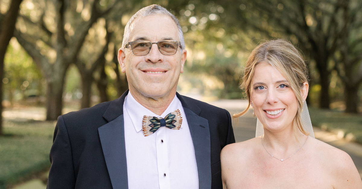 Bryan Workman and his daughter smile on her wedding day.