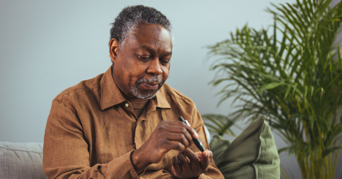 man hands using lancet on finger to check blood sugar or ketones level by glucose meter.