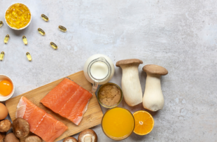Flat lay composition with products rich in vitamin D. Canned tuna, mushrooms, salmon, eggs, milk, and orange juice - great natural sources of Vitamin D.