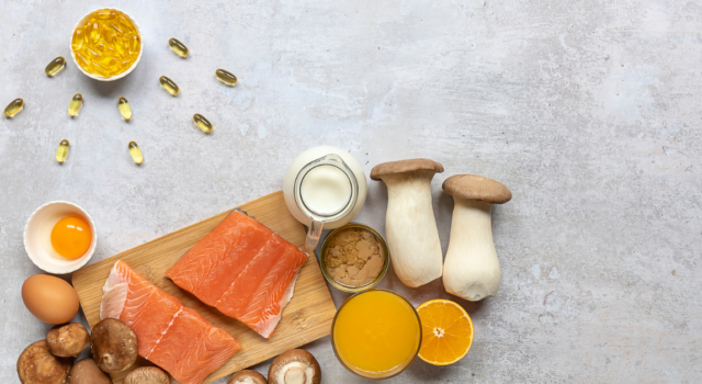 Flat lay composition with products rich in vitamin D. Canned tuna, mushrooms, salmon, eggs, milk, and orange juice - great natural sources of Vitamin D.