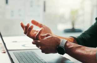 Man, hand pain and typing injury in office, laptop and carpal tunnel tension and inflammation.