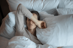 Young woman waking up and feeling tired