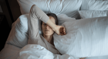 Young woman waking up and feeling tired