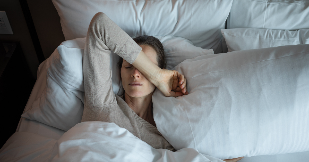 Young woman waking up and feeling tired