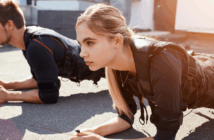 two young hardworking people are leaning on their elbows and doing exercises