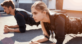 two young hardworking people are leaning on their elbows and doing exercises