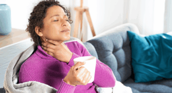 Portrait of black woman suffering sore throat at home