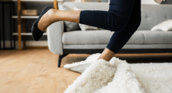 Falldown Hazard. Clumsy Woman Stumbled On Rug