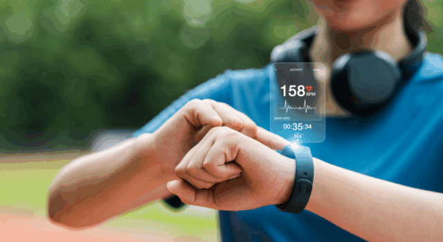 Young woman checking her wristwatch via app to measure her heart rate. Healthy exercise concept. Running, walking.