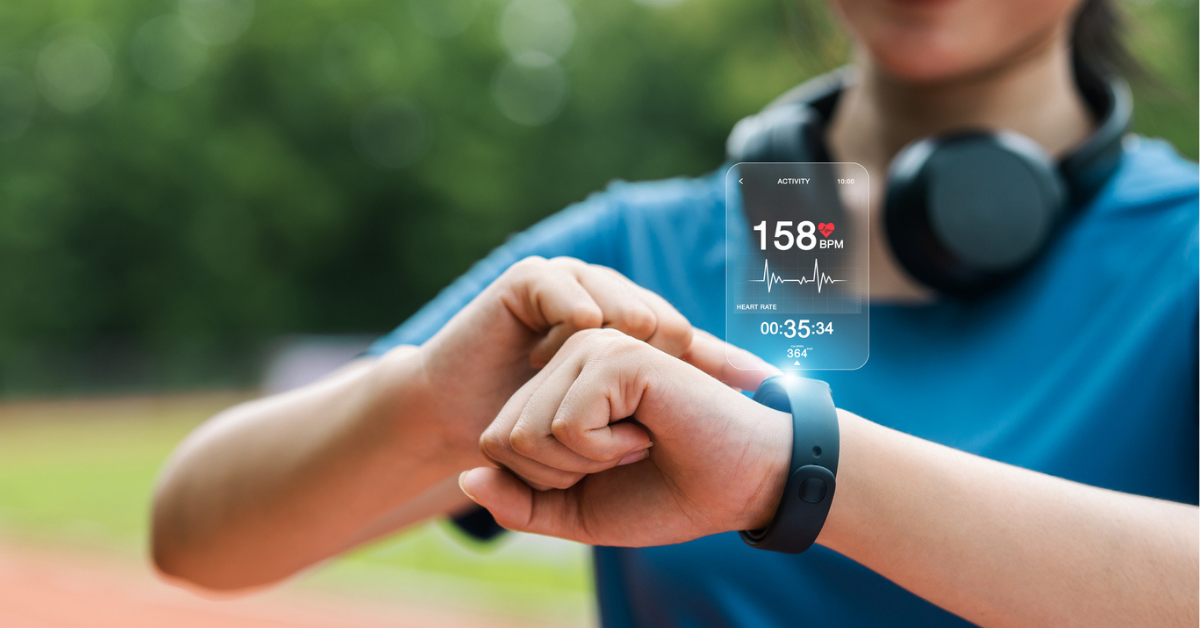 Young woman checking her wristwatch via app to measure her heart rate. Healthy exercise concept. Running, walking.