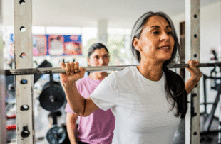 Mature woman doing exercises at gym